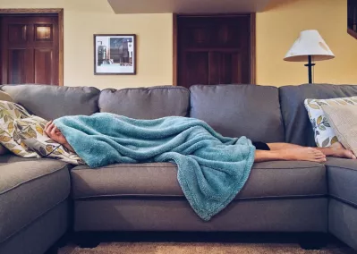 Dear New Parents, Quality Sleep is Possible with an Air Purifier : Tired parent sleeping on sofa